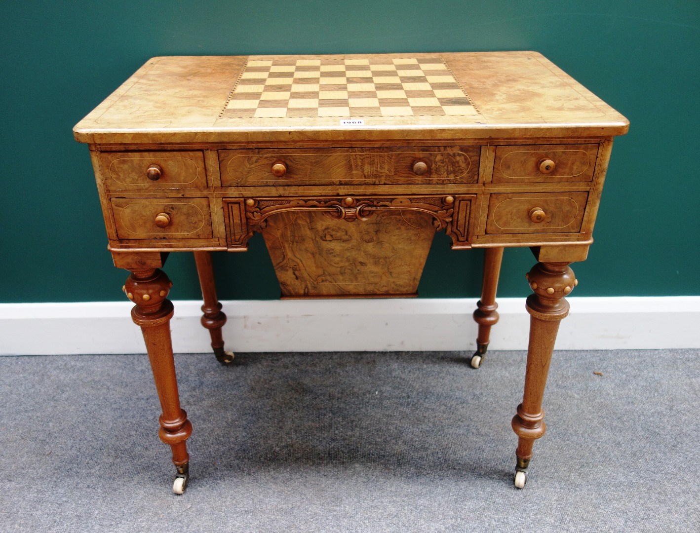 Appraisal: A Victorian figured walnut work games table the chessboard inlaid