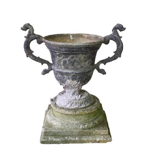 Appraisal: A lead urn with griffin mask head handles the body