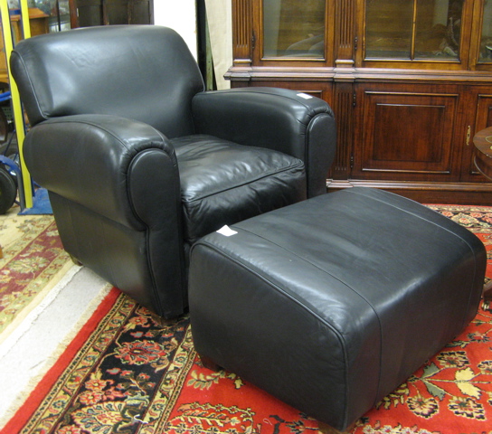 Appraisal: CONTEMPORARY BLACK LEATHER ARMCHAIR AND OTTOMAN The Leather Furniture Co