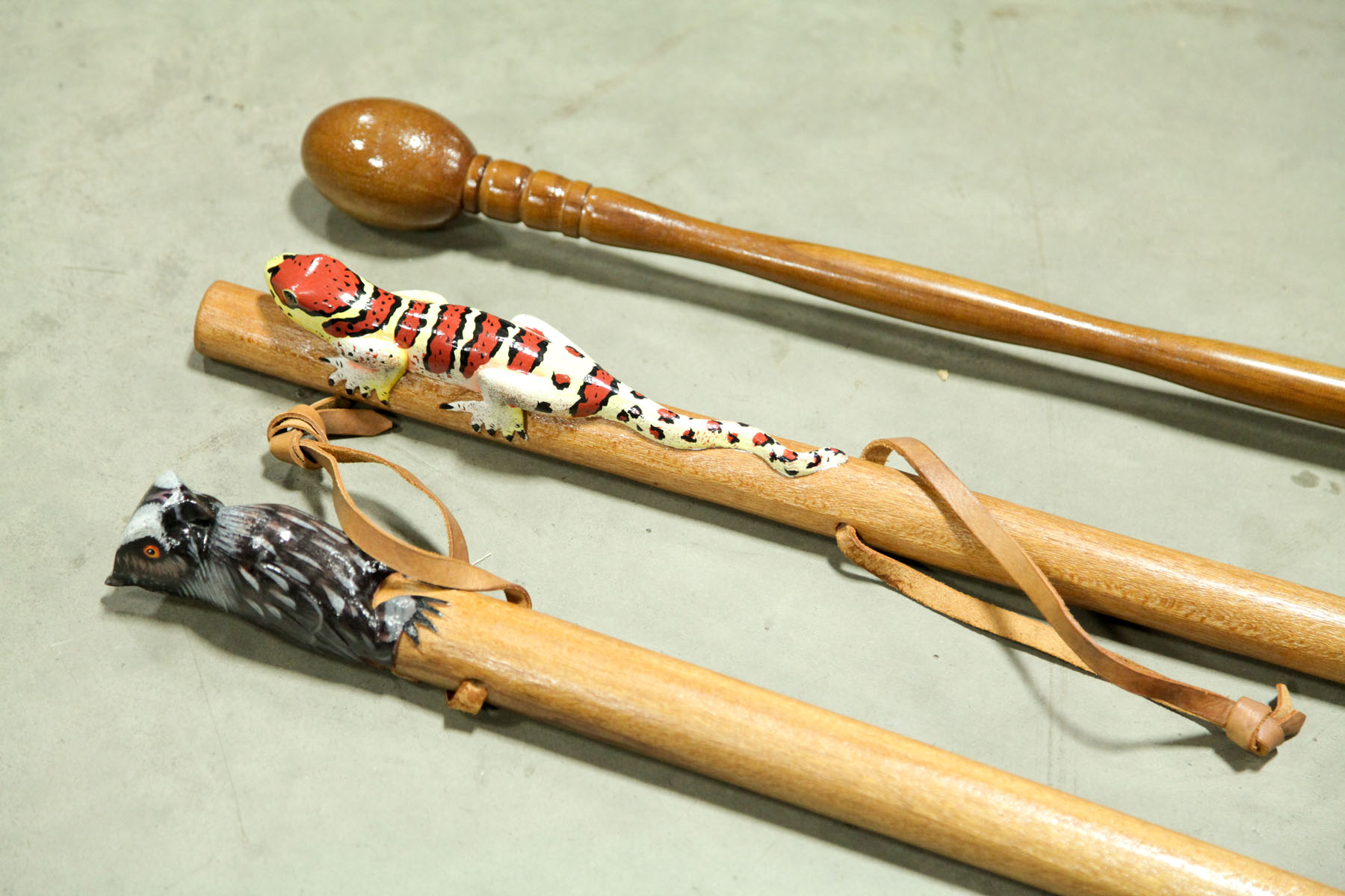 Appraisal: THREE WALKING STICKS American contemporary Very nice Owl and Lizard