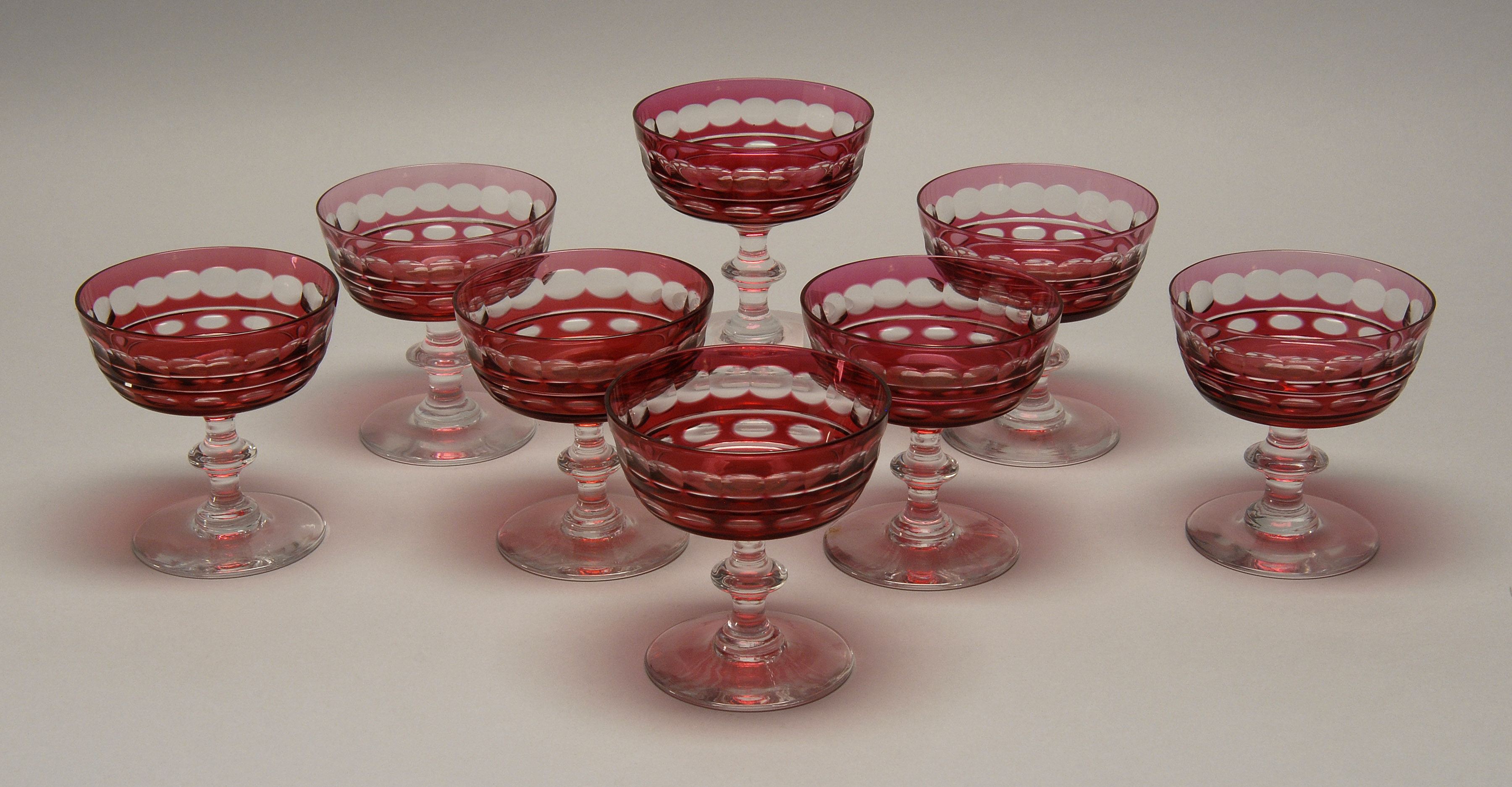 Appraisal: SET OF EIGHT OVERLAY GLASS CHAMPAGNE COUPES Probably English Early