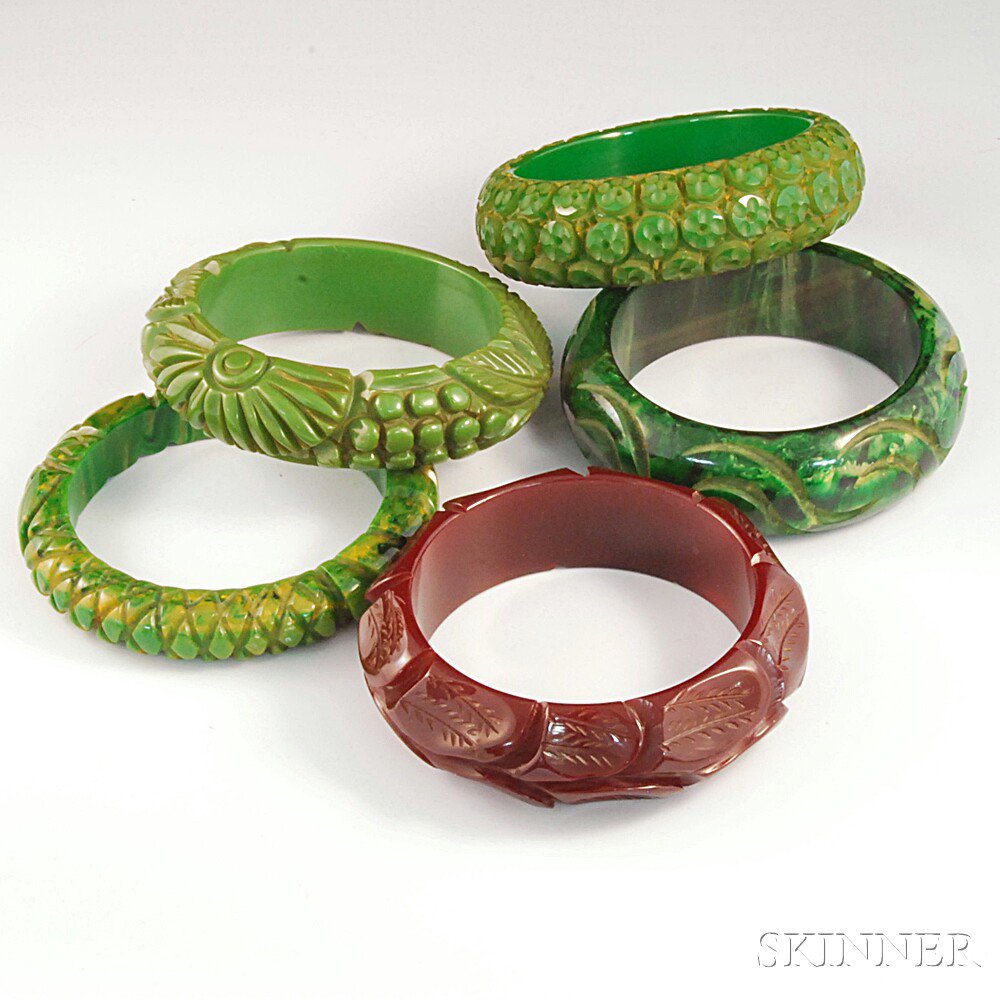 Appraisal: Five Carved Bakelite Bangle Bracelets one burgundy and four in