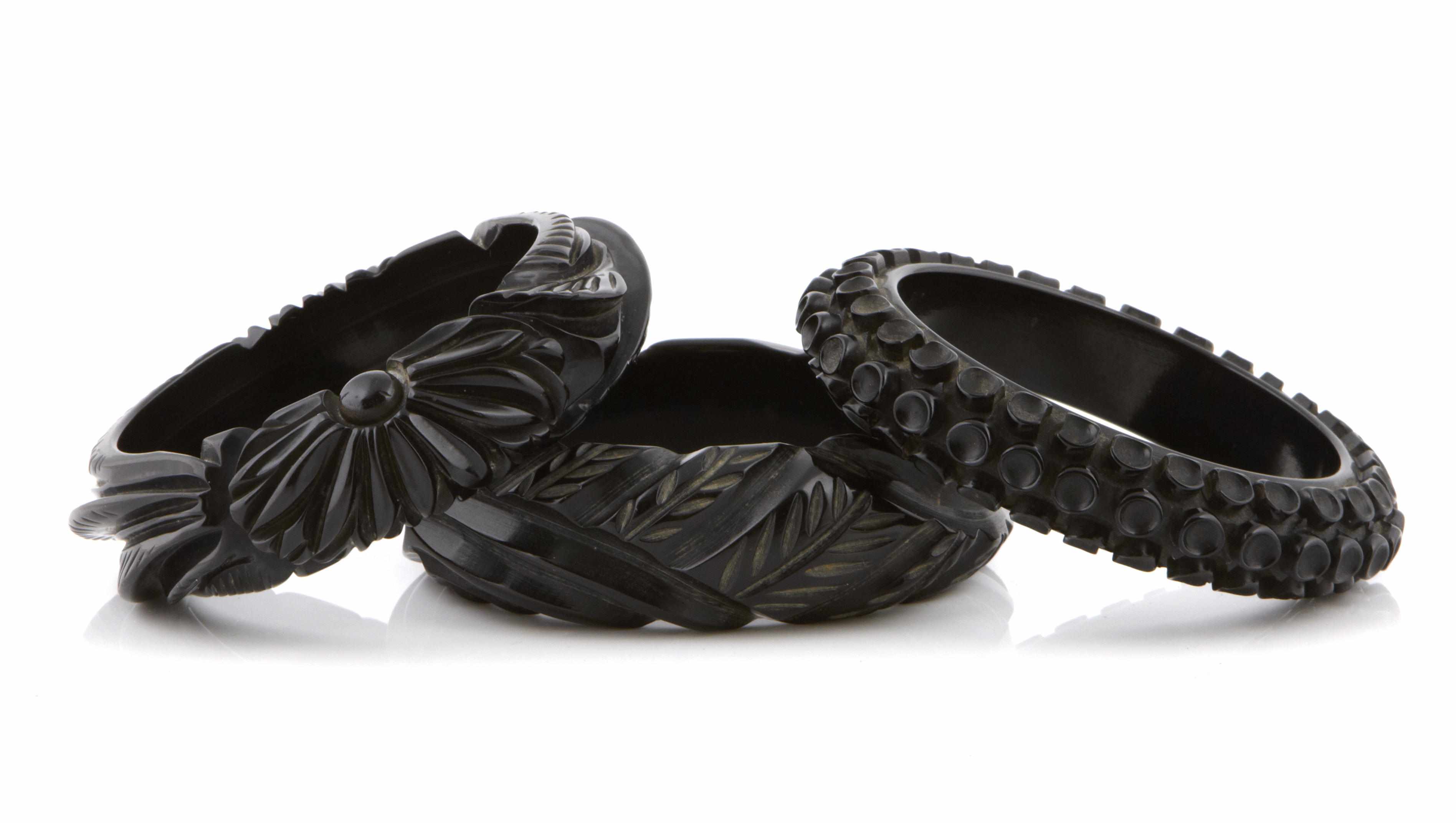 Appraisal: Three deeply carved black Bakelite bangle bracelets each diameter in