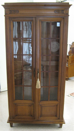 Appraisal: WALNUT CABINET BOOKCASE French early th century having four adjustable