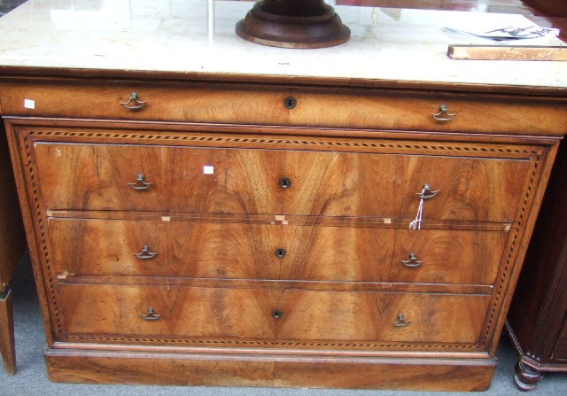 Appraisal: A French walnut commode the white marble top over one