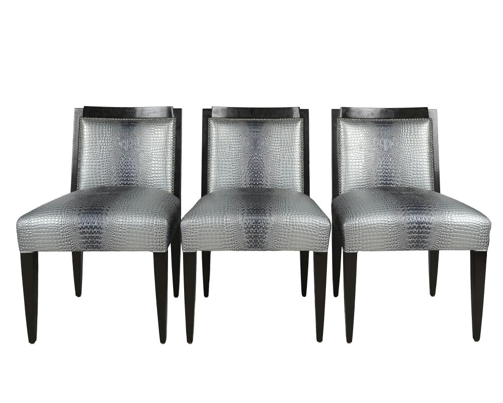 Appraisal: THREE BLACK LACQUERED SIDE CHAIRSeach with textured faux leather upholstery