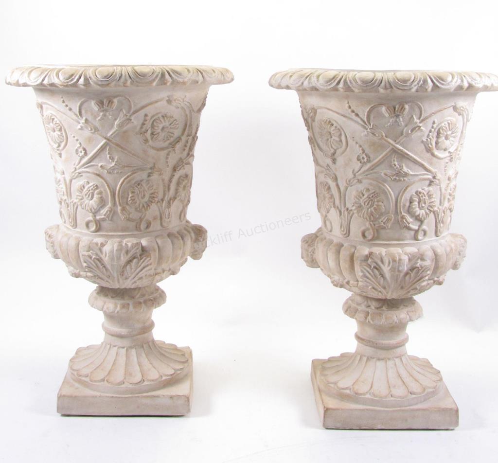 Appraisal: A pair of cast concrete urns with coated finish floral