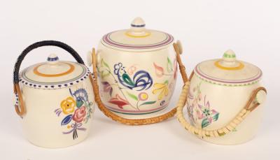 Appraisal: Poole Pottery three floral biscuit barrels with raffia handles one