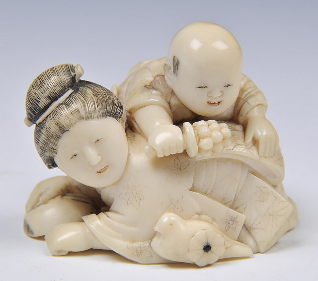 Appraisal: A JAPANESE IVORY OKIMONO of a mother and infant she