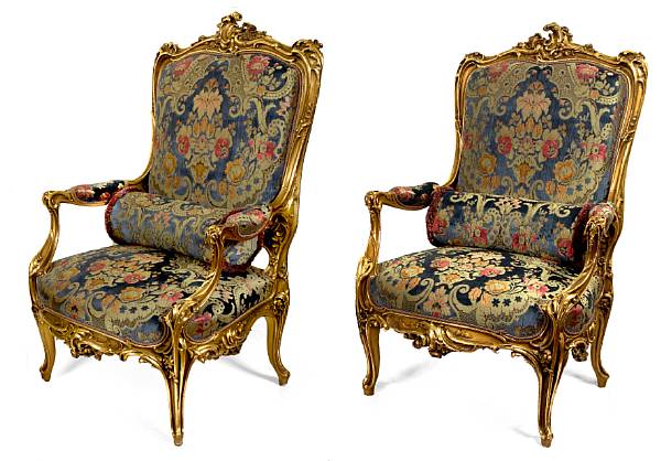 Appraisal: A pair of Rococo style giltwood fauteuils En suite with