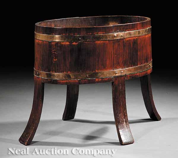 Appraisal: An English Fruitwood Copper-Bound Wine Cooler c oval-form on outswept