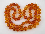 Appraisal: An amber bead necklace largest bead approx mm wide approx