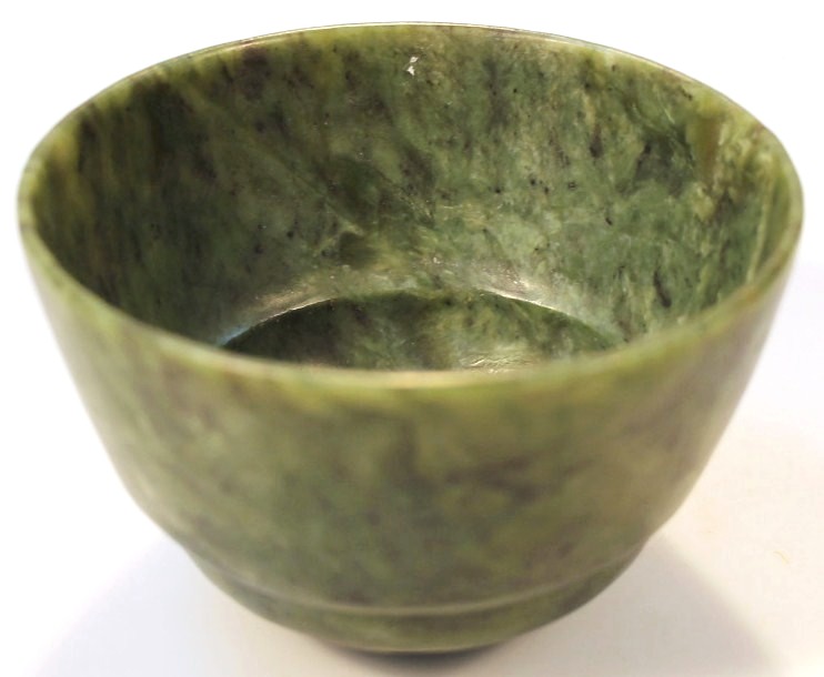 Appraisal: A late thC Chinese green jade bowl of textured tapering