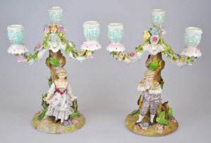 Appraisal: Pair of Continental porcelain three-branch candelabra floral encrusted with a