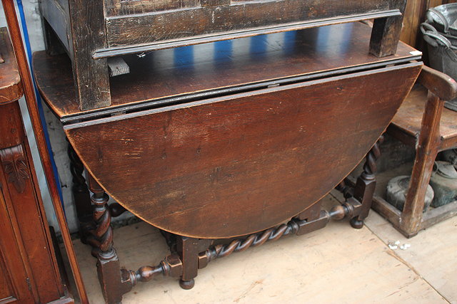 Appraisal: AN OAK GATELEG TABLE with barley twist legs and stretchers