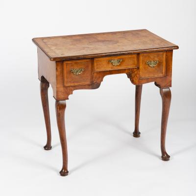 Appraisal: A George II walnut lowboy with herringbone banding fitted three