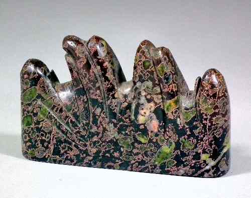 Appraisal: A Chinese hardstone brush rest with green pink and blackened