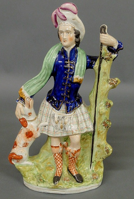 Appraisal: Colorful Staffordshire standing Scotsman with dog c h x w