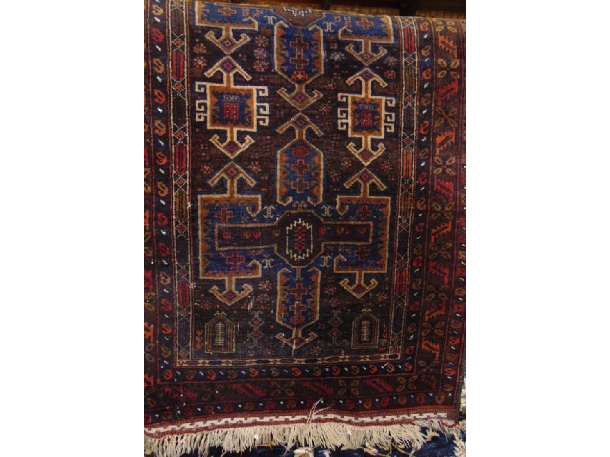 Appraisal: A Persian style wool rug with multi-medallion centre upon a