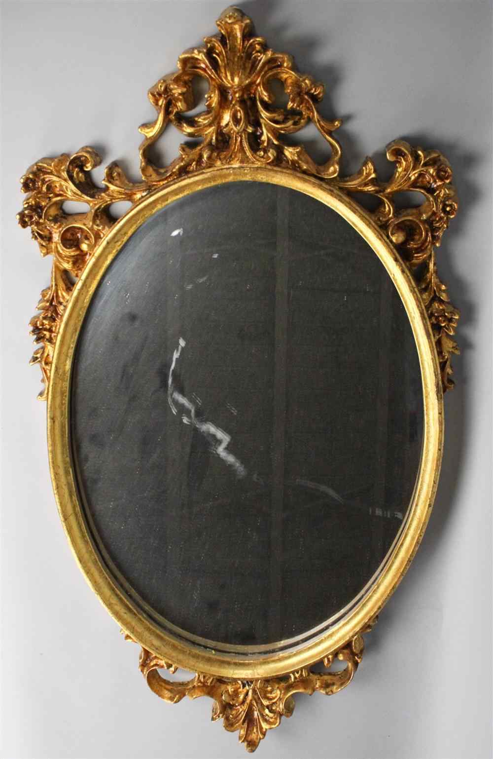 Appraisal: CARVED GOLD PAINTED OVAL MIRROR having a gold painted frame