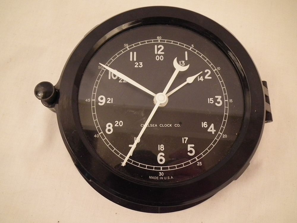 Appraisal: CHELSEA SHIPS HATCH CLOCK Modern black resin ship's hatch wall