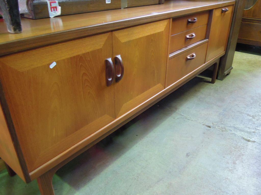 Appraisal: A long teakwood sideboard probably G Plan fitted and enclosed