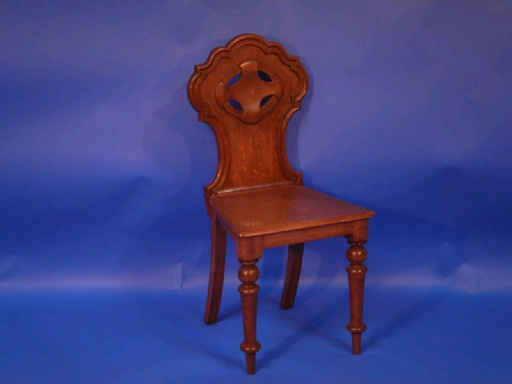 Appraisal: A Victorian carved oak hall chair with shaped back raised