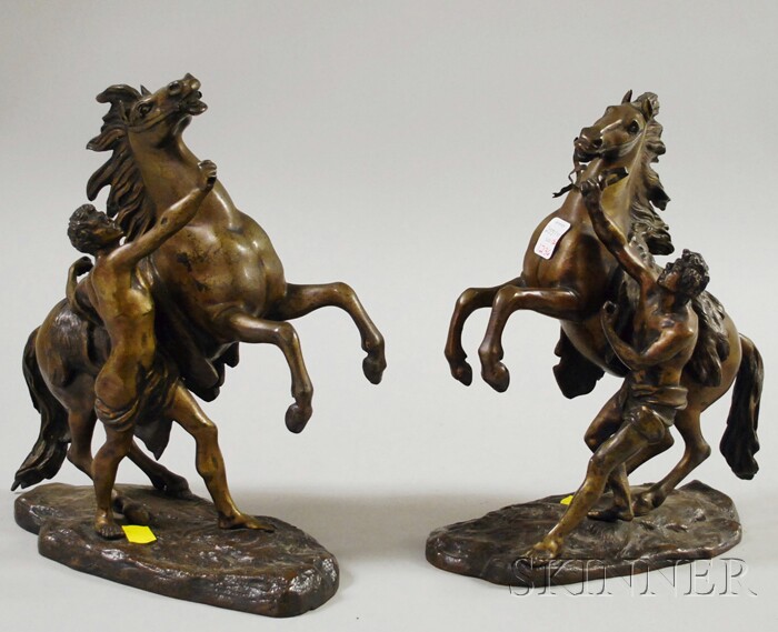 Appraisal: Two Classical-style Bronze Horse and Handler Figural Groups early to