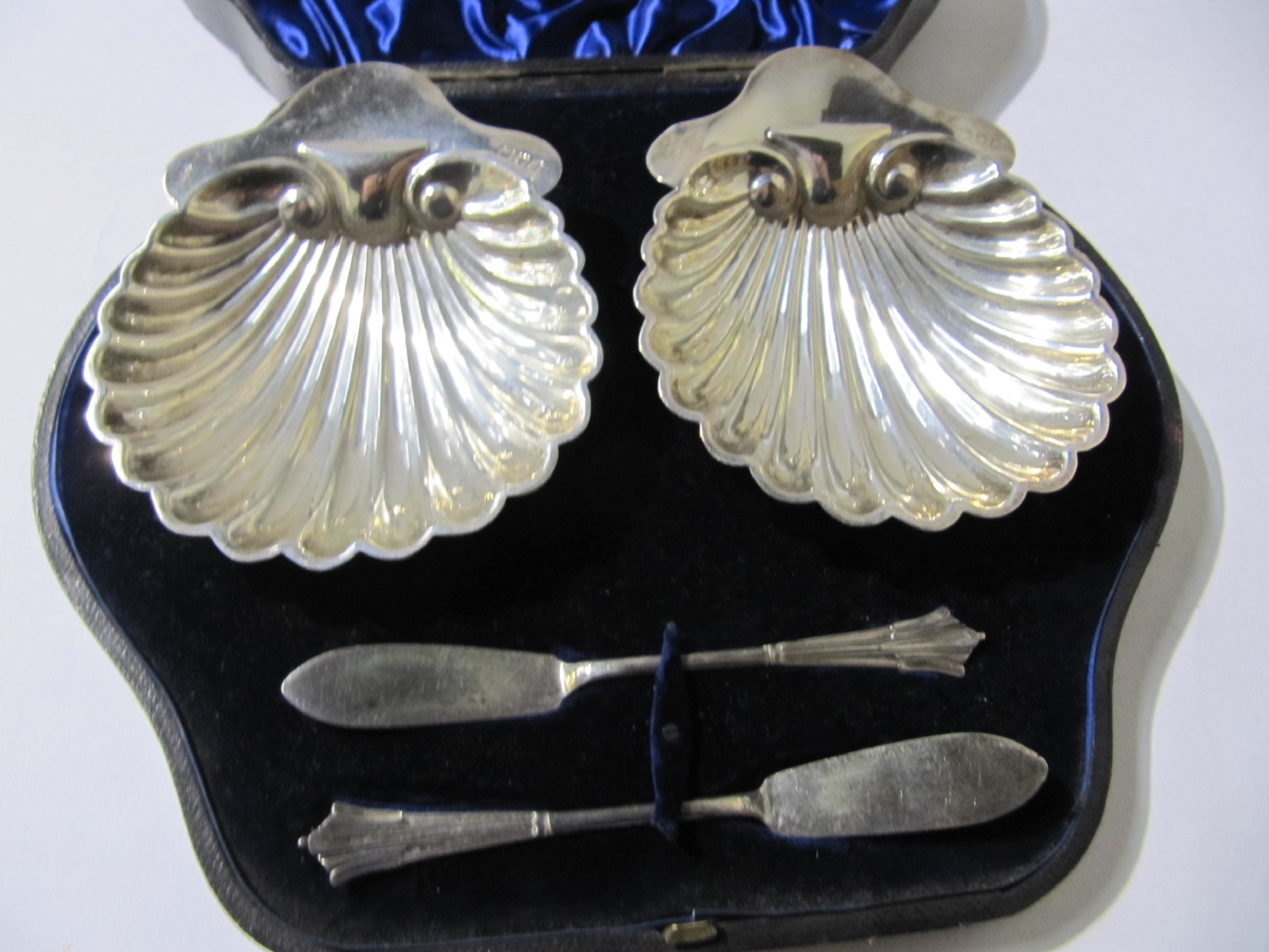 Appraisal: A cased pair of silver shell shaped butter dishes London