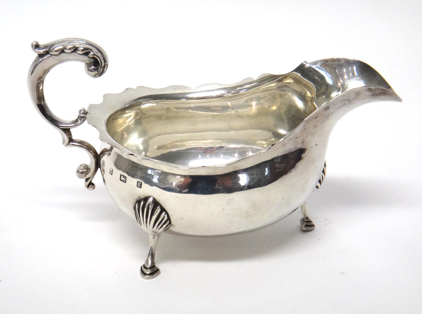 Appraisal: A silver large sauceboat with a scrolling handle shaped rim