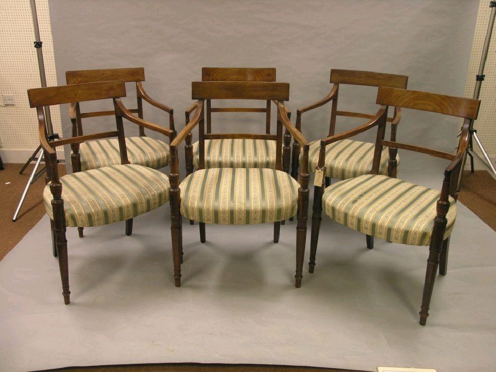 Appraisal: A set of six Sheraton period mahogany dining armchairs overhanging