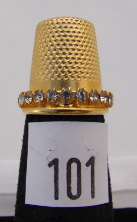 Appraisal: Gold tone thimble with clear stones on band