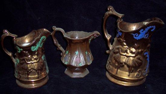 Appraisal: Three copper lustre jugs