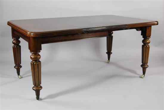 Appraisal: A Victorian mahogany extending dining table on turned and gadrooned