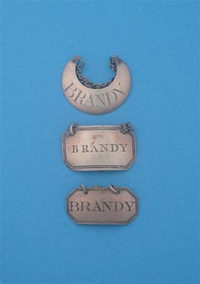 Appraisal: Three 'BRANDY' labels a George III unmarked crescent a canted