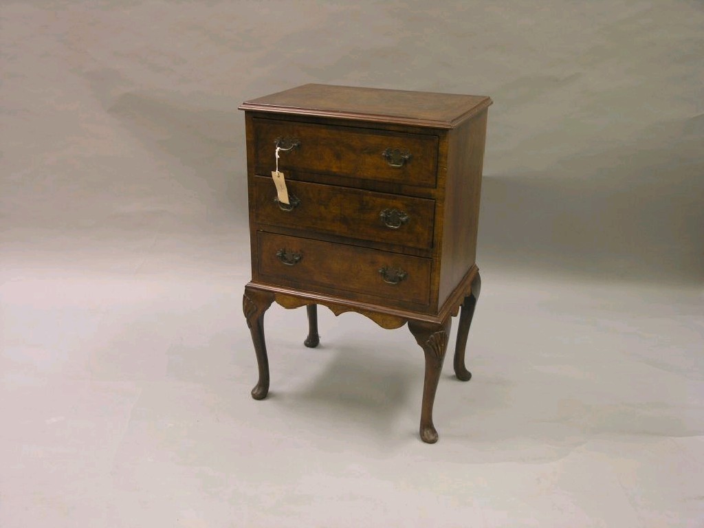 Appraisal: A burr walnut veneered chest three cross-banded drawers each with