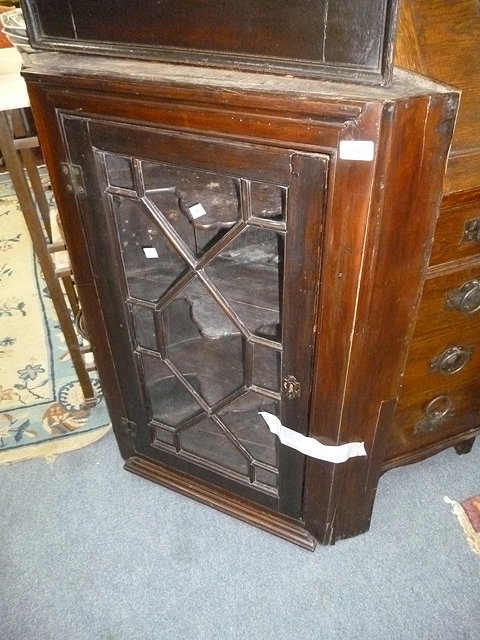 Appraisal: AN ANTIQUE MAHOGANY GLAZED CORNER CUPBOARD together with a caned