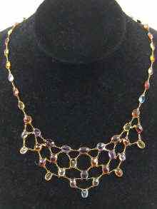 Appraisal: A multi gem necklace set in yellow metal tests ct