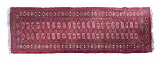 Appraisal: A Bokhara Wool Runner with repeating medallions on a red