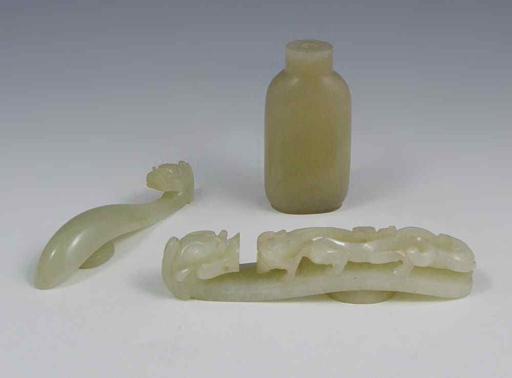 Appraisal: JADE BELT CLASPS AND A JADE SNUFF BOTTLE Each of