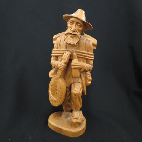 Appraisal: Carved Wooden Figurine of an Old Man with backpack guitar