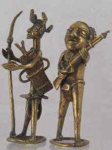 Appraisal: Two African tribal figures one carrying a flintlock gun the