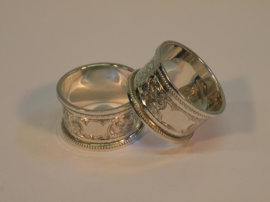 Appraisal: A pair of silver napkin rings each engraved with scrolls