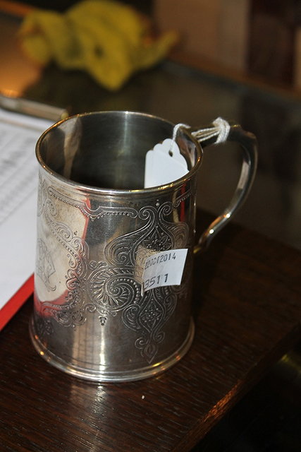 Appraisal: A SILVER TANKARD of tapering cylindrical form with loop handle