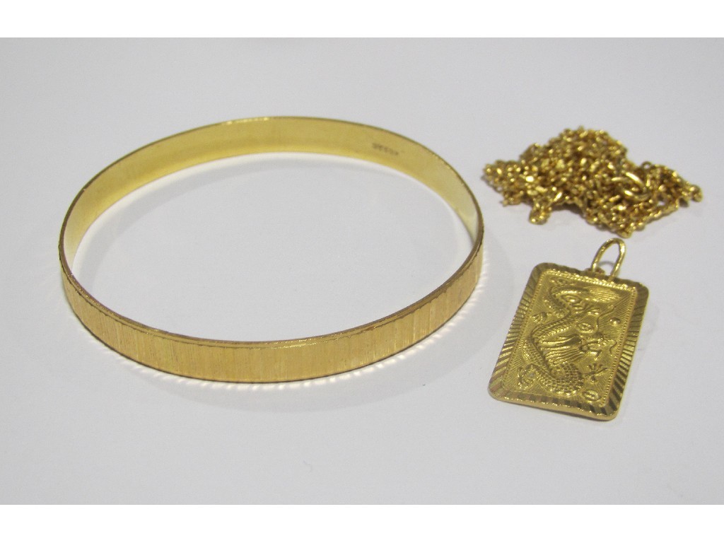 Appraisal: Lot comprising yellow metal bangle pendant on neckchain Approximately gms