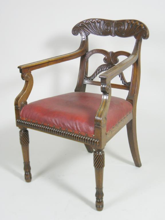 Appraisal: A Regency mahogany Elbow Chair with detailed carved back stuff-over