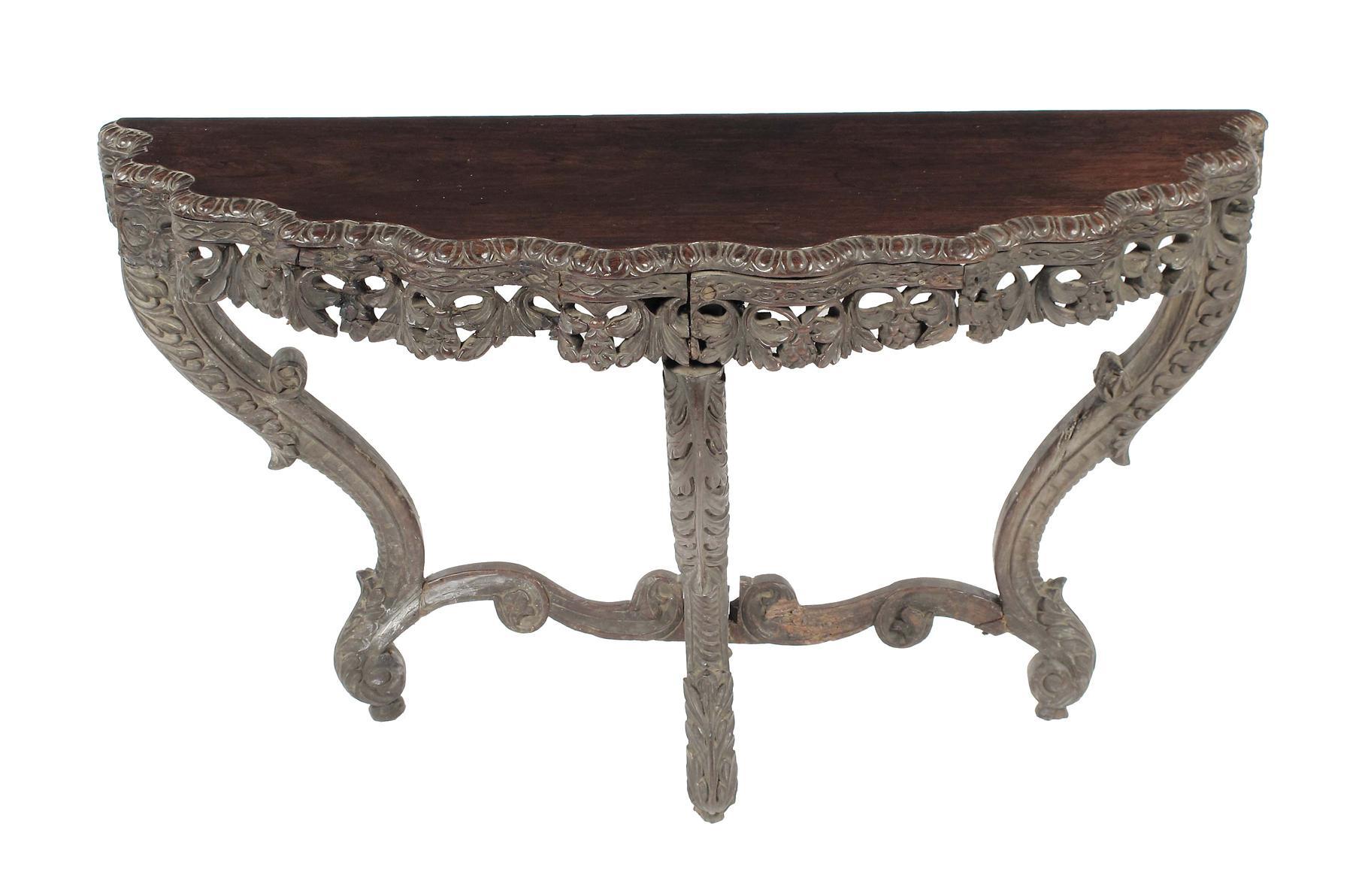 Appraisal: An Anglo-Indian carved rosewood demi-lune console table