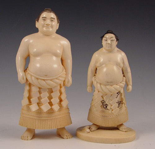 Appraisal: JAPANESE CARVED IVORY FIGURES OF SUMO WRESTLERS Each is signed