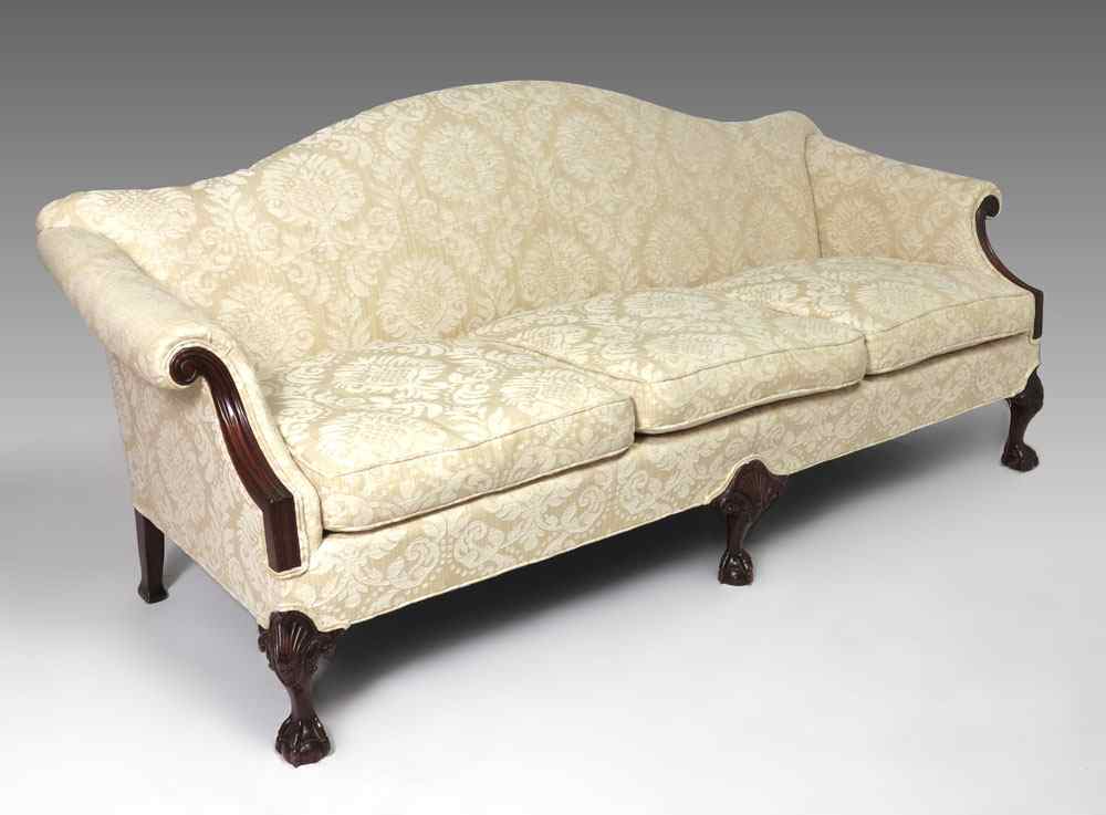 Appraisal: CHIPPENDALE STYLE CAMEL BACK SOFA Beige pattern upholstery with carved