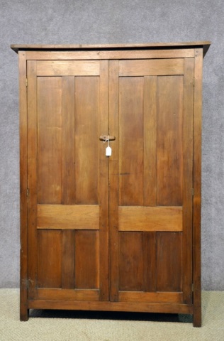 Appraisal: Walnut Two-Door Flat-Back CupboardHaving two double-paneled doors concealing four shelves